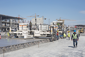 The taxiways in the apron area are being paved in concrete using three Wirtgen slipform pavers.