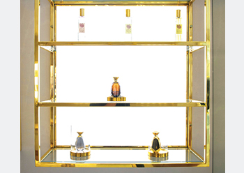 The dedicated fragrance section of the store is separated from the clothing area with an ivory and gold partition.