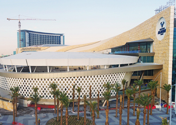 The curving forms and sweeping lines of the facade appear to emanate from the arena.