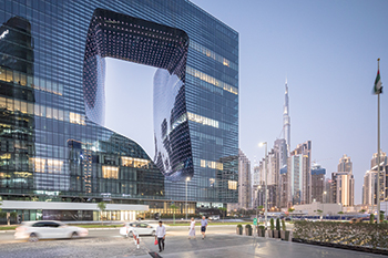 The cube-shaped Opus ....reflective flat-panelled glass on the exterior and a wavy dark blue glass in the void.