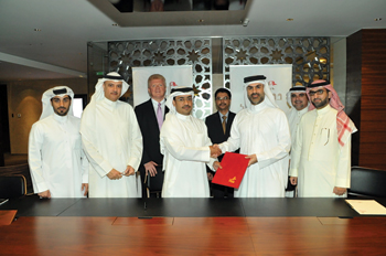Diyar Al Muharraq and Bin Faqeeh officials shake hands on the Dragon Apartments agreement.