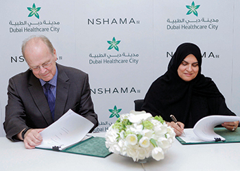 Durie (left) and Dr Gurg sign the agreement.