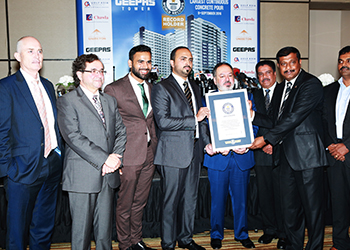 Officials pose with the Guinness certificate.