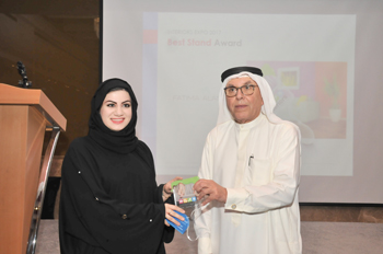 An official of Fatima Alansari Design and Execution receives the award for the Interiors expo.